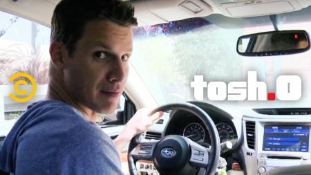 Daniel Tosh poses a picture in his Subaru.